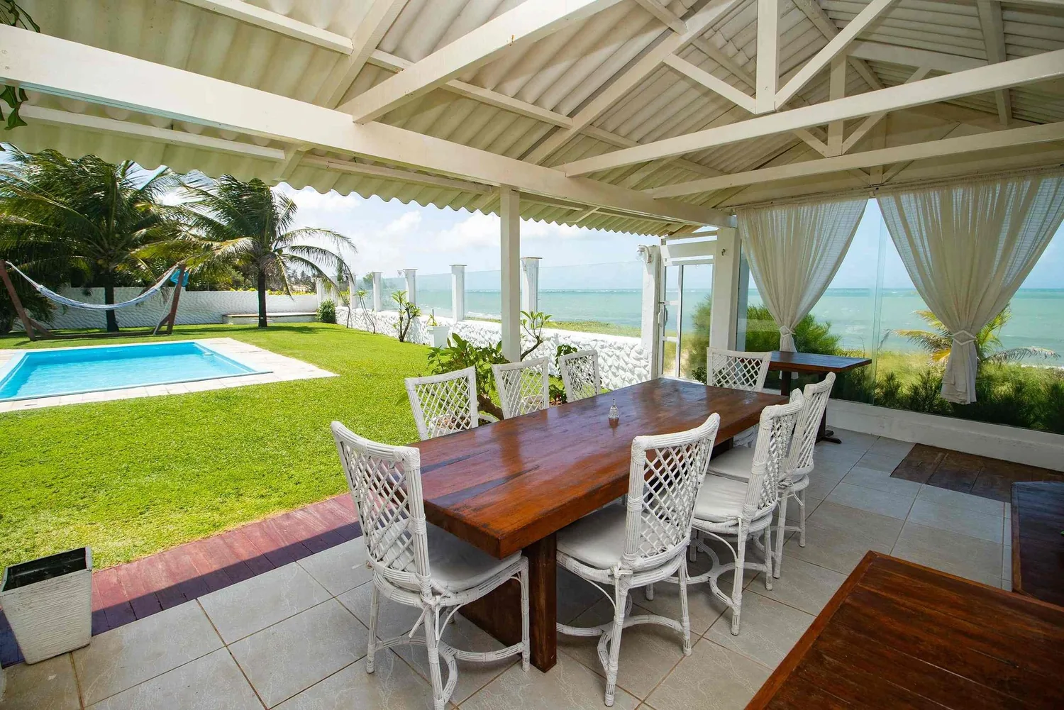 Shaded sea-view terrace with the pool and the Atlantic behind it